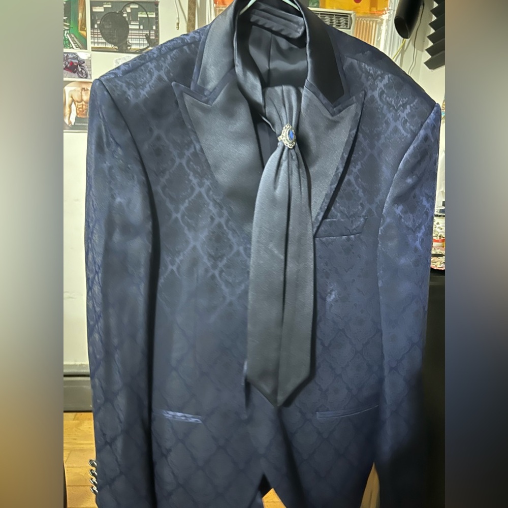 Two-piece navy blue blazer and pants suit include tie